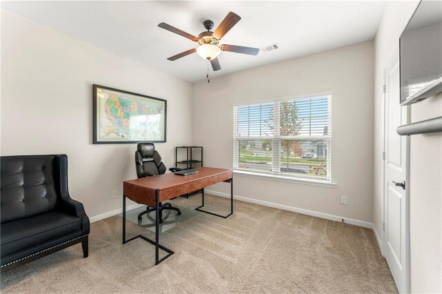 office space featuring ceiling fan and light colored carpet