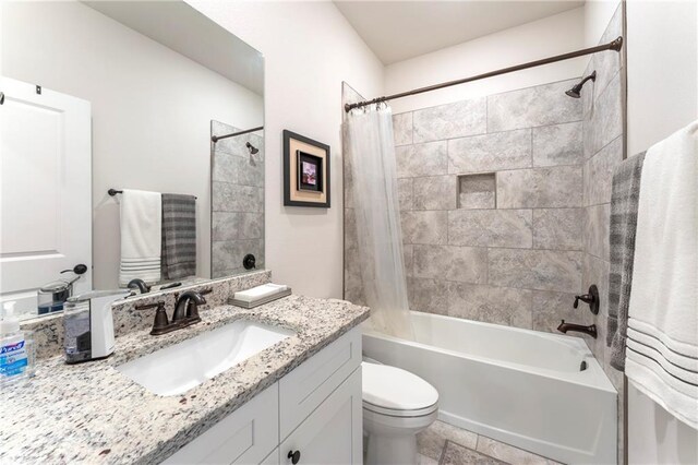 full bathroom featuring shower / bath combo with shower curtain, vanity, and toilet