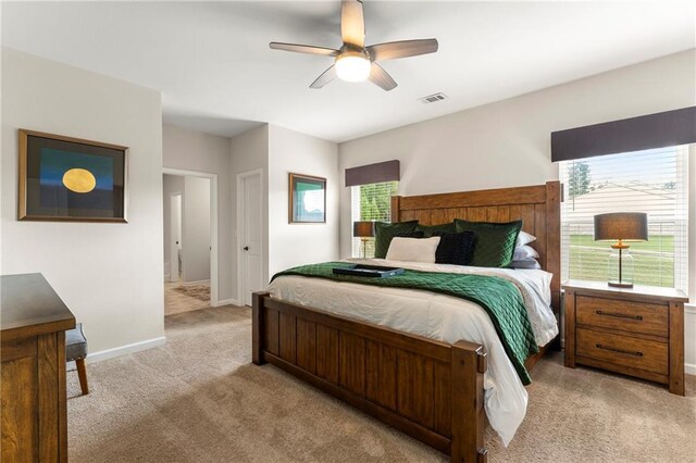 bedroom featuring light carpet and ceiling fan