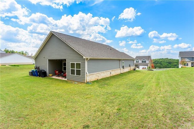 back of house with a lawn