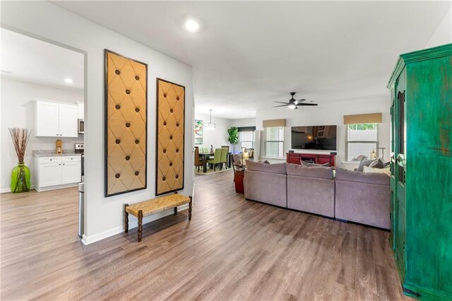 living room featuring ceiling fan and light wood-type flooring