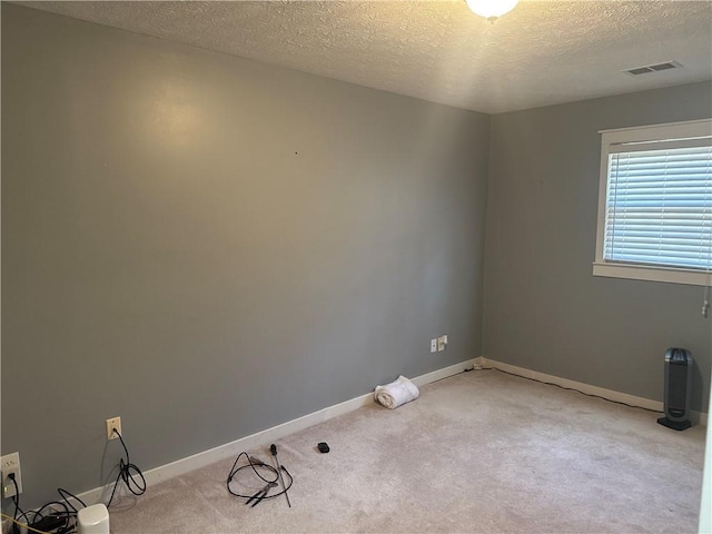 2943 E Howell Dr, Lawrenceville, GA 30044 - unfurnished room with baseboards, a textured ceiling, visible vents, and light carpet