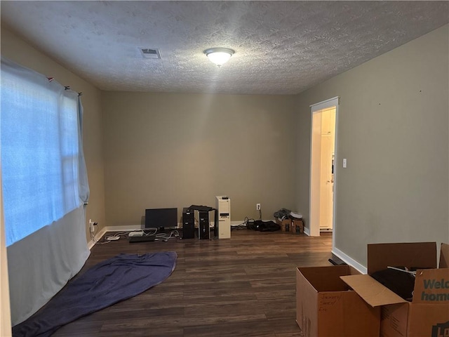 2943 E Howell Dr, Lawrenceville, GA 30044 - bedroom with visible vents, a textured ceiling, baseboards, and wood finished floors