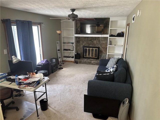 2943 E Howell Dr, Lawrenceville, GA 30044 - living area with carpet flooring, a ceiling fan, a stone fireplace, and a textured ceiling