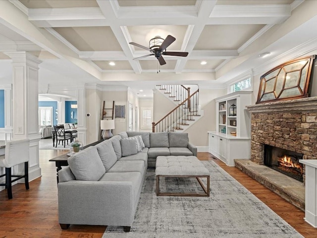 living room with wood-type flooring, a wealth of natural light, and a fireplace