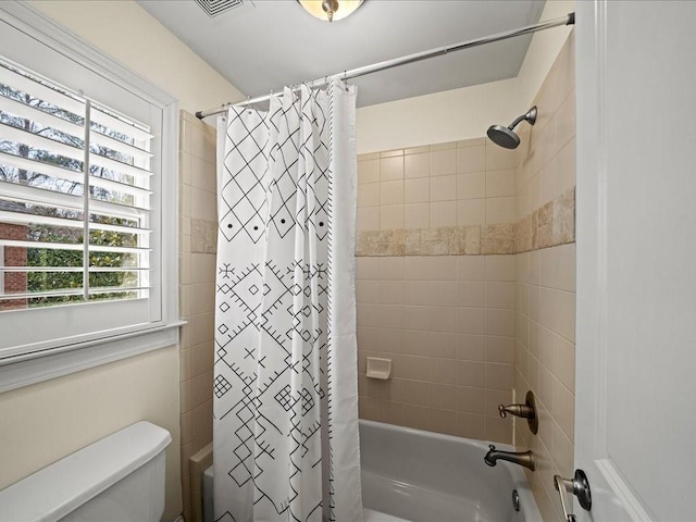 bathroom with toilet and shower / bathtub combination with curtain