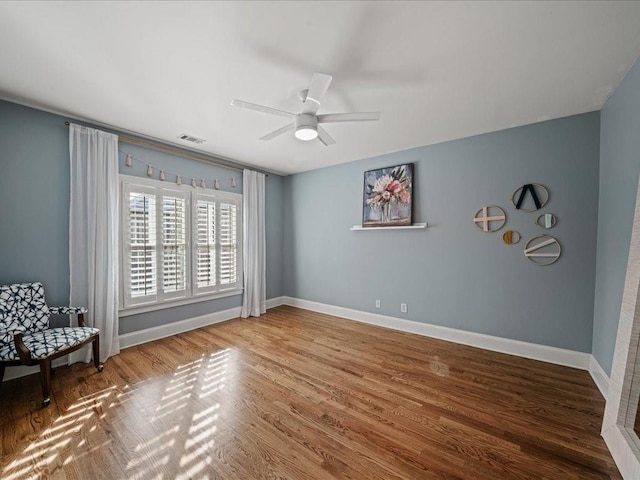 interior space with wood-type flooring and ceiling fan