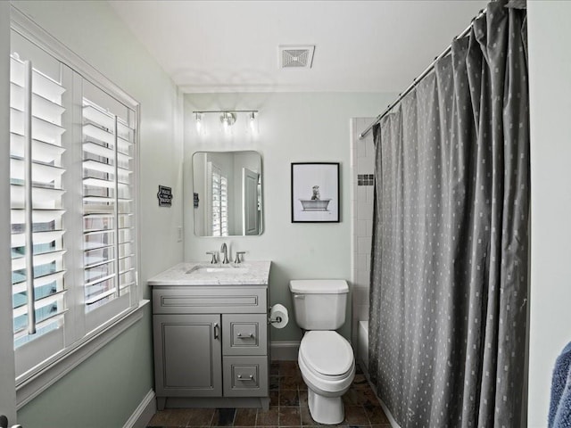 full bathroom featuring vanity, shower / tub combo, and toilet