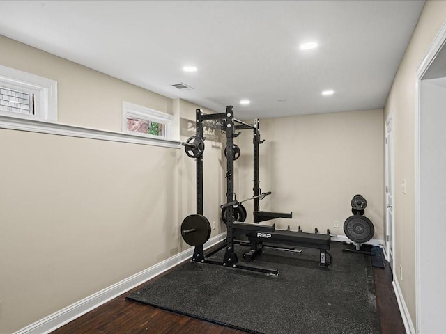 exercise area with dark hardwood / wood-style flooring