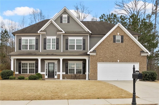 view of front of home featuring a front lawn, a porch, concrete driveway, an attached garage, and brick siding