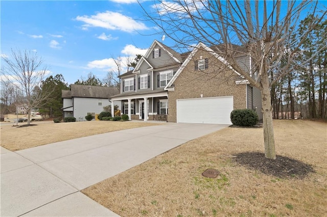 view of front of house featuring brick siding, a front lawn, a porch, a garage, and driveway