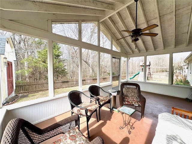 sunroom / solarium featuring ceiling fan and vaulted ceiling with beams