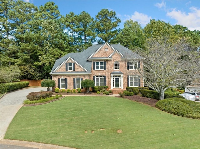 colonial-style house featuring a front lawn