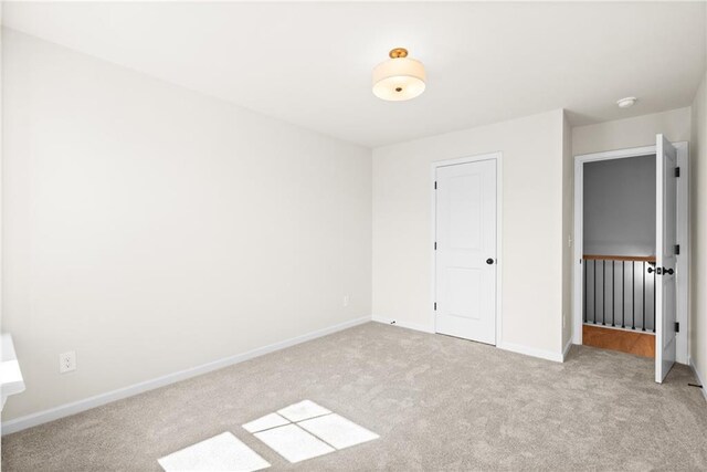 unfurnished bedroom featuring baseboards and carpet floors