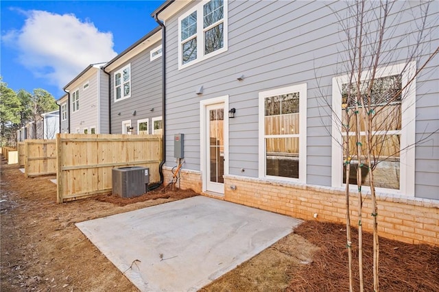 exterior space with a patio, cooling unit, fence, and brick siding