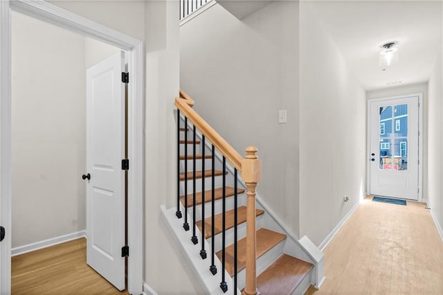 interior space featuring stairway, baseboards, and wood finished floors