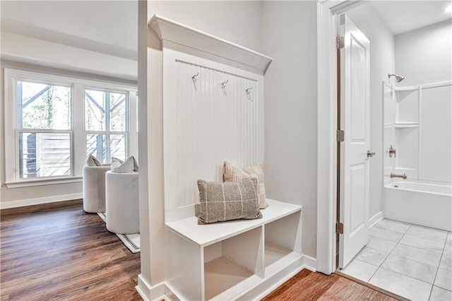 mudroom with baseboards and wood finished floors