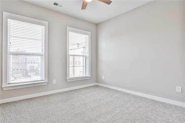 carpeted empty room with baseboards and ceiling fan