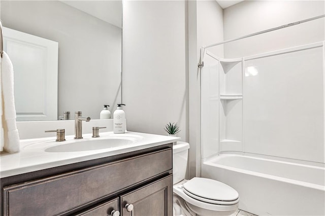 full bath featuring toilet, vanity, and shower / washtub combination