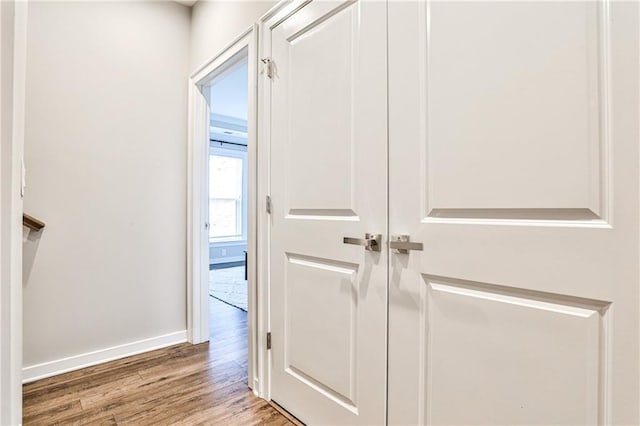 hall with wood finished floors and baseboards