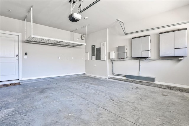 garage with electric panel, a garage door opener, and baseboards