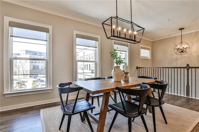 dining area featuring a notable chandelier, dark wood-type flooring, baseboards, and ornamental molding