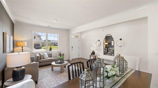 living room with wood-type flooring and crown molding