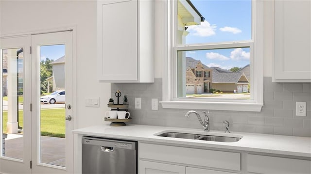 kitchen with dishwasher, sink, decorative backsplash, and white cabinets