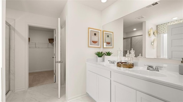 bathroom featuring an enclosed shower and vanity