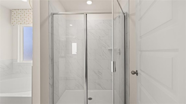 bathroom featuring separate shower and tub