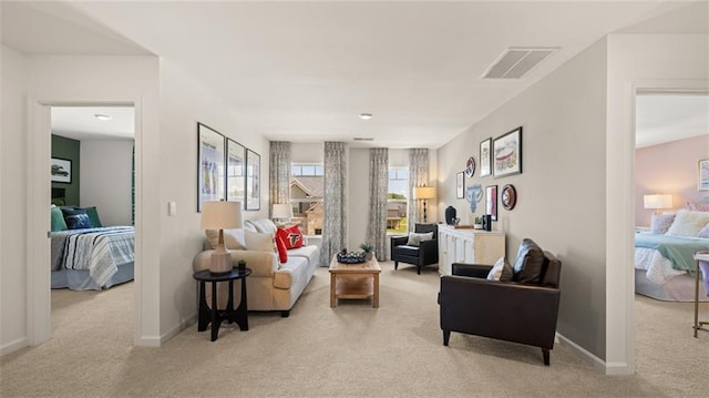 sitting room featuring plenty of natural light and light colored carpet