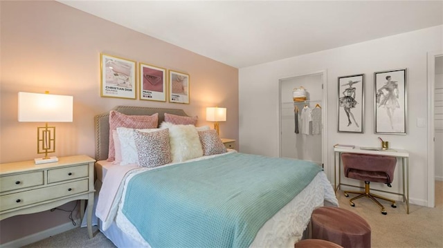 bedroom featuring a closet, a spacious closet, and light carpet