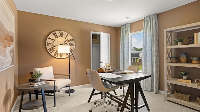 dining room with light colored carpet and a wealth of natural light