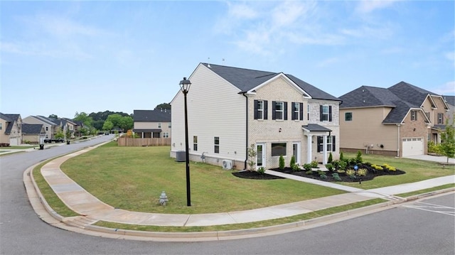 view of front facade with a front yard and a garage