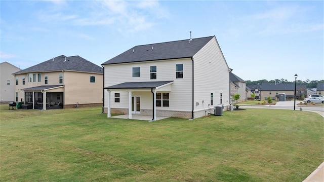 back of house with cooling unit and a yard