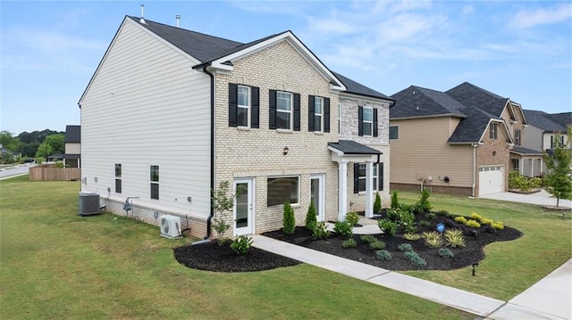 view of front of home with a front lawn and central AC unit