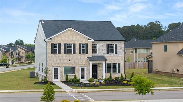 view of front of home with a front lawn and cooling unit