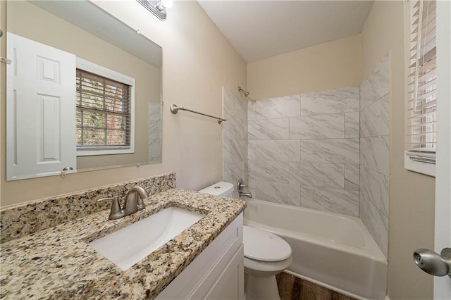 full bathroom with toilet, tiled shower / bath combo, and vanity