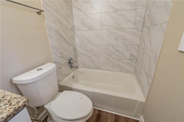 bathroom with toilet, tiled shower / bath combo, and hardwood / wood-style floors