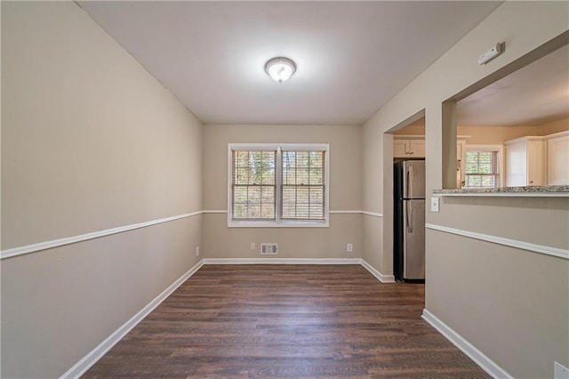 unfurnished room featuring dark hardwood / wood-style flooring