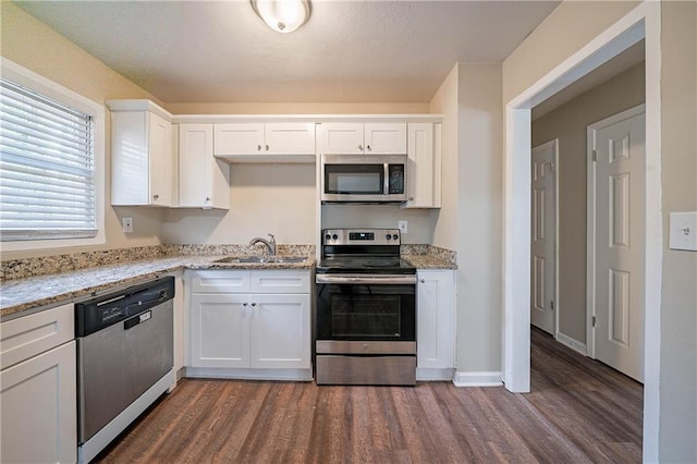 kitchen featuring white cabinets, light stone countertops, sink, and stainless steel appliances