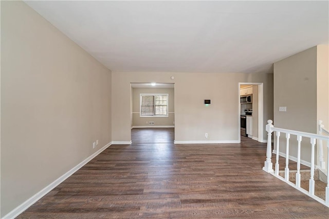 spare room featuring dark hardwood / wood-style flooring