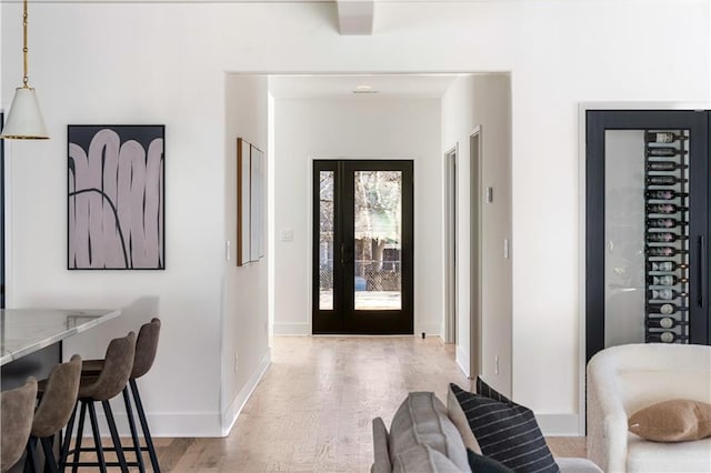 foyer entrance featuring light wood-style flooring and baseboards
