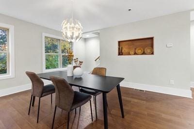 dining room featuring a notable chandelier and dark hardwood / wood-style flooring