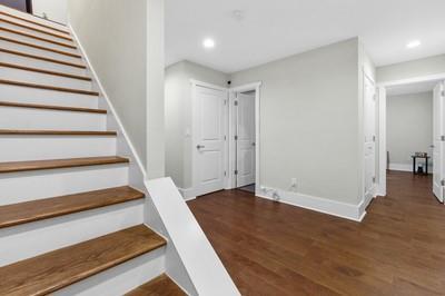 stairway with hardwood / wood-style flooring