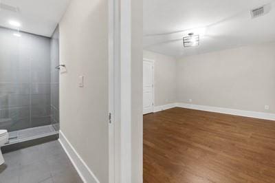 bathroom featuring hardwood / wood-style floors and toilet