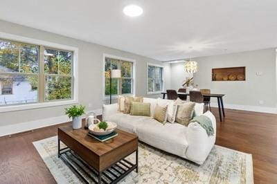 living room featuring wood-type flooring and a chandelier