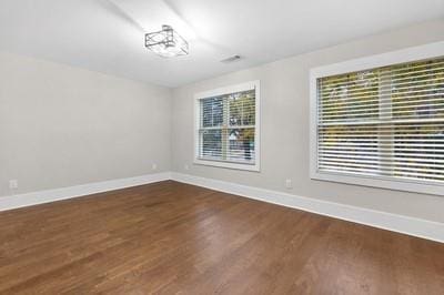 unfurnished room featuring plenty of natural light and hardwood / wood-style floors