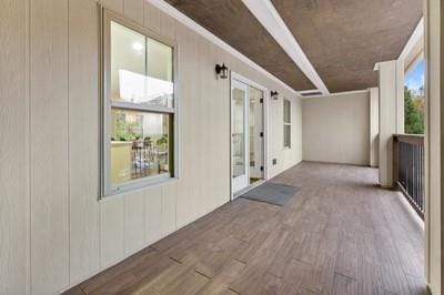 hallway featuring hardwood / wood-style flooring and a healthy amount of sunlight