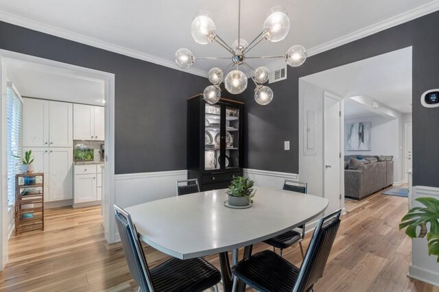 46 Ivy Rdg NE, Atlanta, GA 30342 - dining space featuring ornamental molding, light wood-style floors, a chandelier, and a wainscoted wall